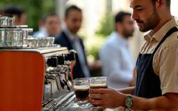 Professional barista preparing espresso drinks at an event
